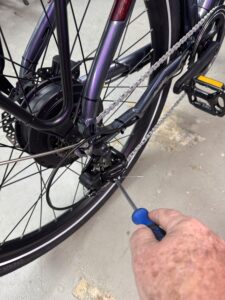 Bicycle chain derailleur getting a much-needed adjustment.