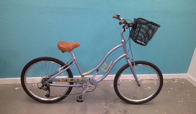 A vibrant 7-speed bike with a basket on a Marco Island path near Tigertail Beach, ideal for relaxed island cruising.