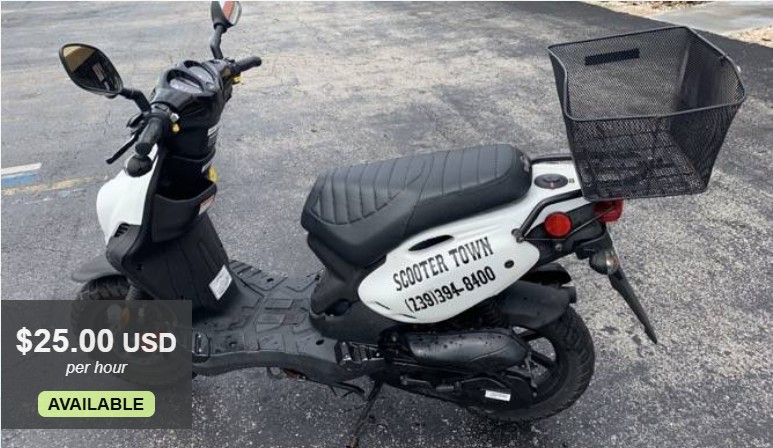 Image of a white gas-powered motor scooter